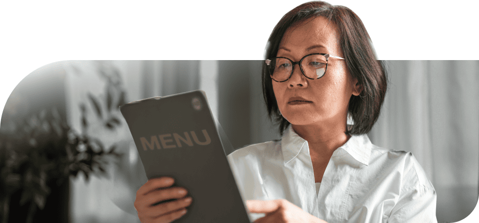Woman with presbyopia reading a dinner menu