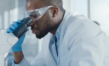 Lab scientist looking into a microscope