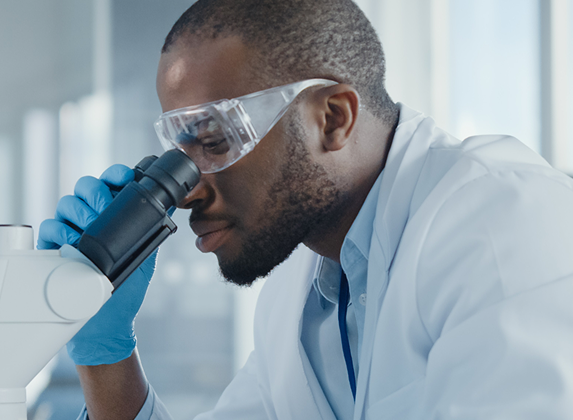 Lab scientist looking into a microscope